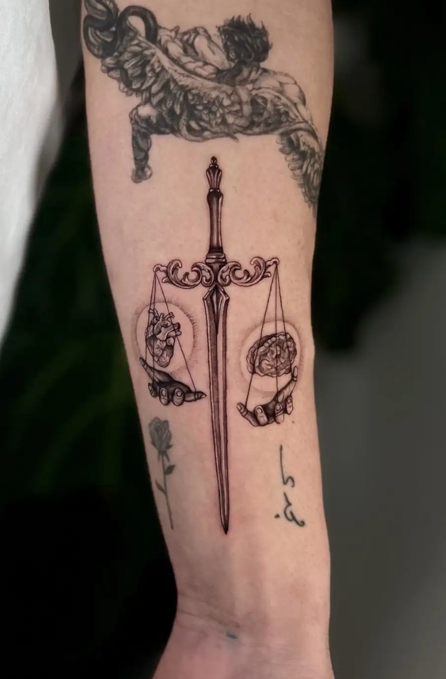 Scales of justice tattoo with heart and brain balance by Ayah at Omnia Tattoo Melbourne